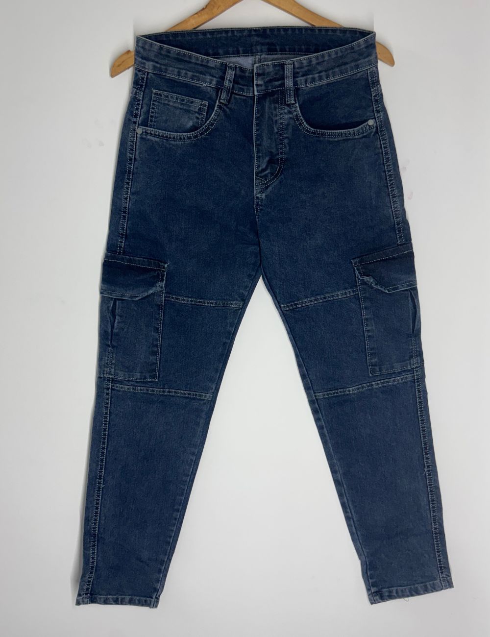 Blue jeans on a hanger against a white background
